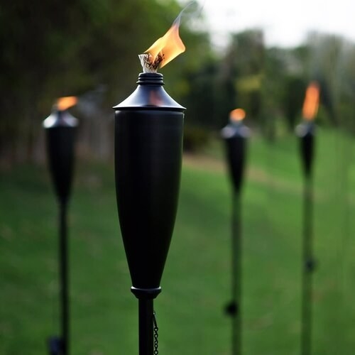 Four lit torches in a yard