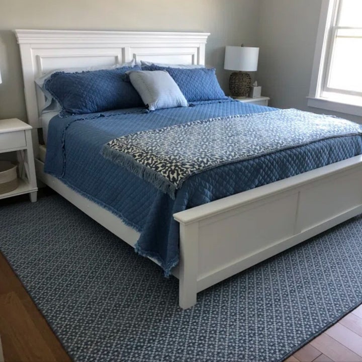 Blue quilt set on white bedframe