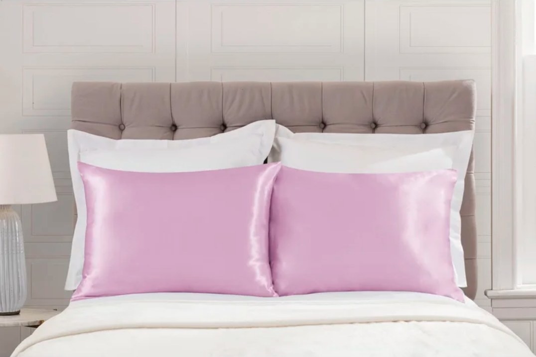 pink satin pillows on bed