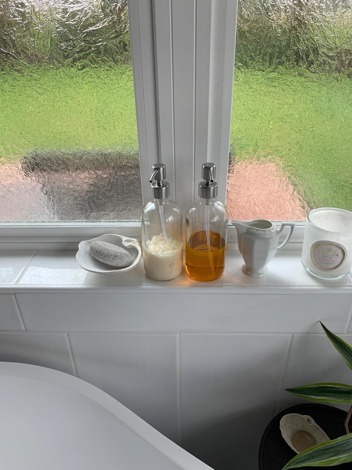 The soap dispensers are shown on a window sill