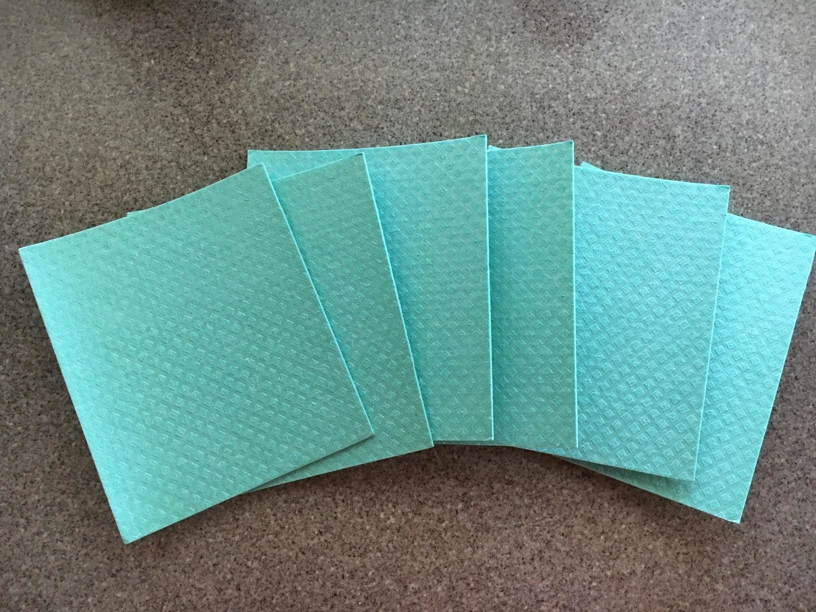 Reviewer&#x27;s photo of the teal blue towels spread out on counter