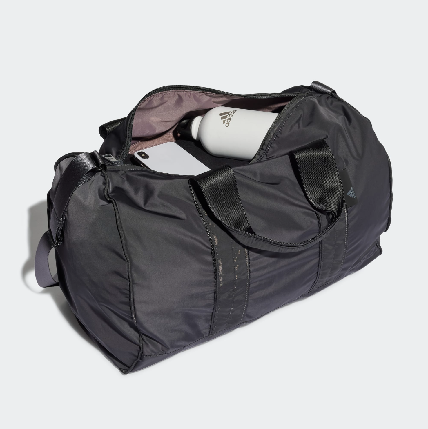 The duffle bag filled with a phone, water bottle, and clothes
