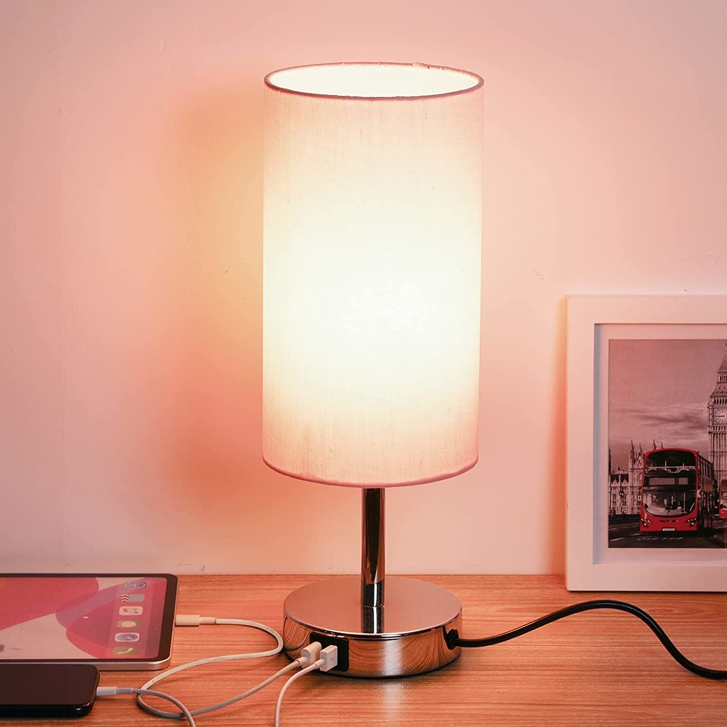 a simple nightstand light charing up two devices via the usb ports in the base