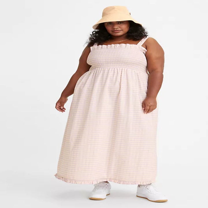 model wearing a light pink long scrunchie dress
