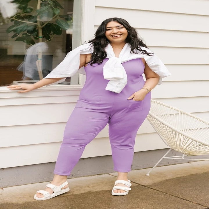 a model wearing a sleeveless knit jumpsuit in light purple