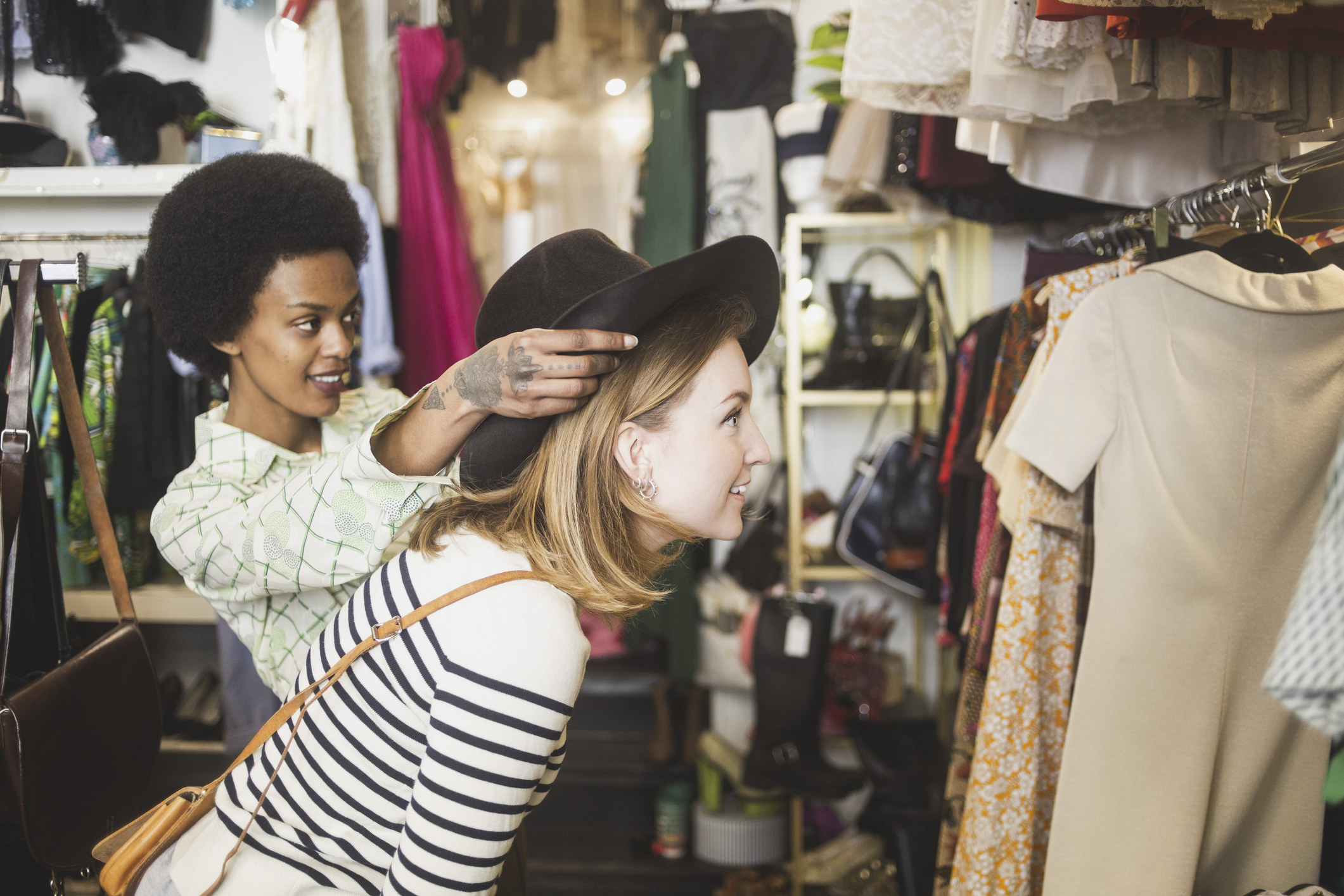 A worker helping a woman in a thrift store