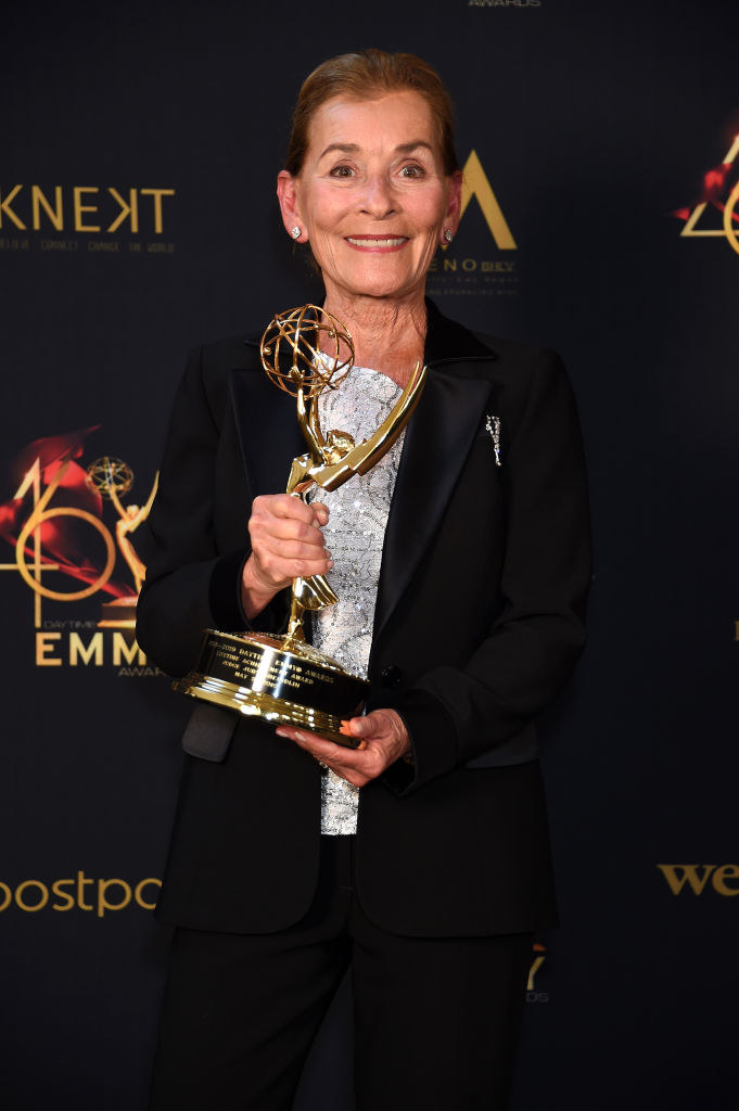 Judge Judy holding her Emmy