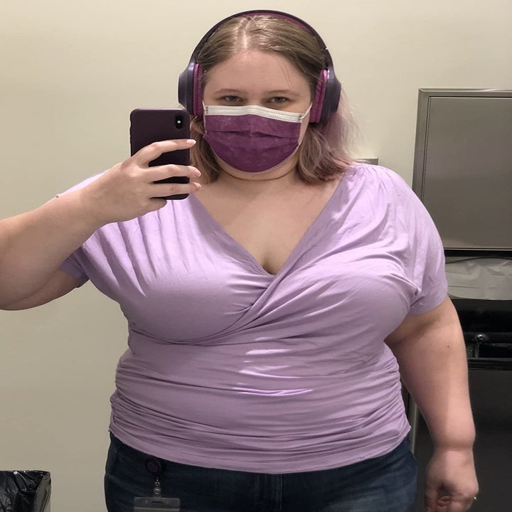 a reviewer wearing the wrap top in light purple
