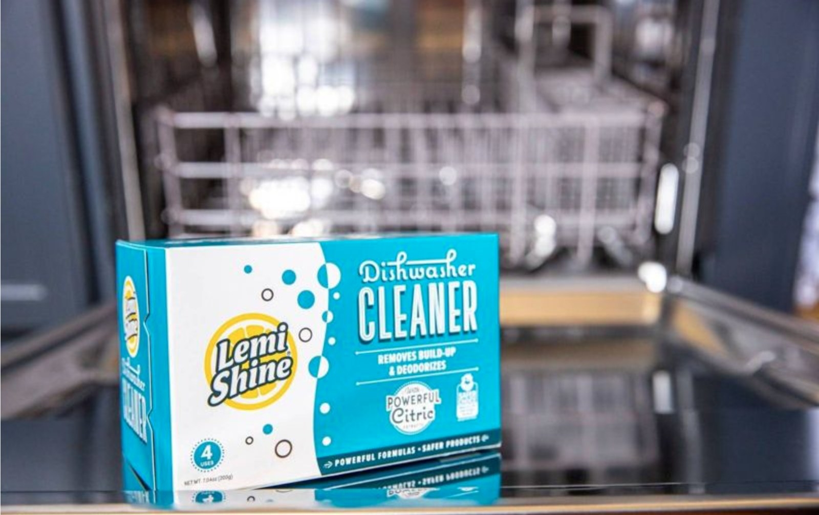 the box of cleaner in front of a dishwasher