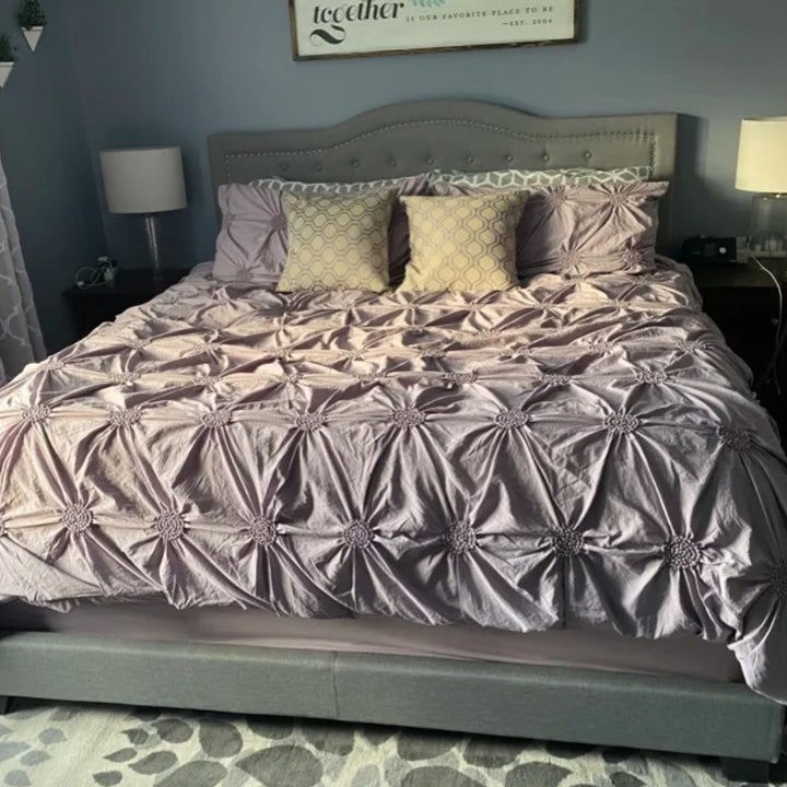 the duvet cover in purple on a reviewer's bed