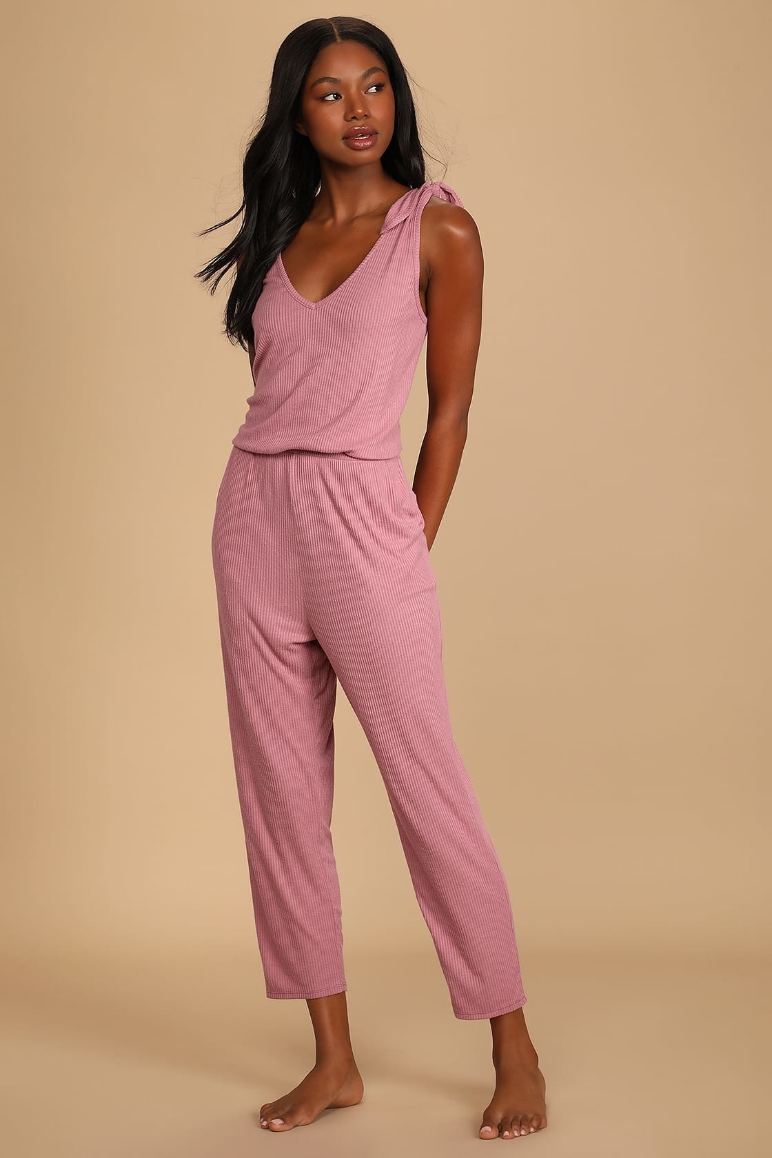 Model wearing pink sleeveless jumpsuit
