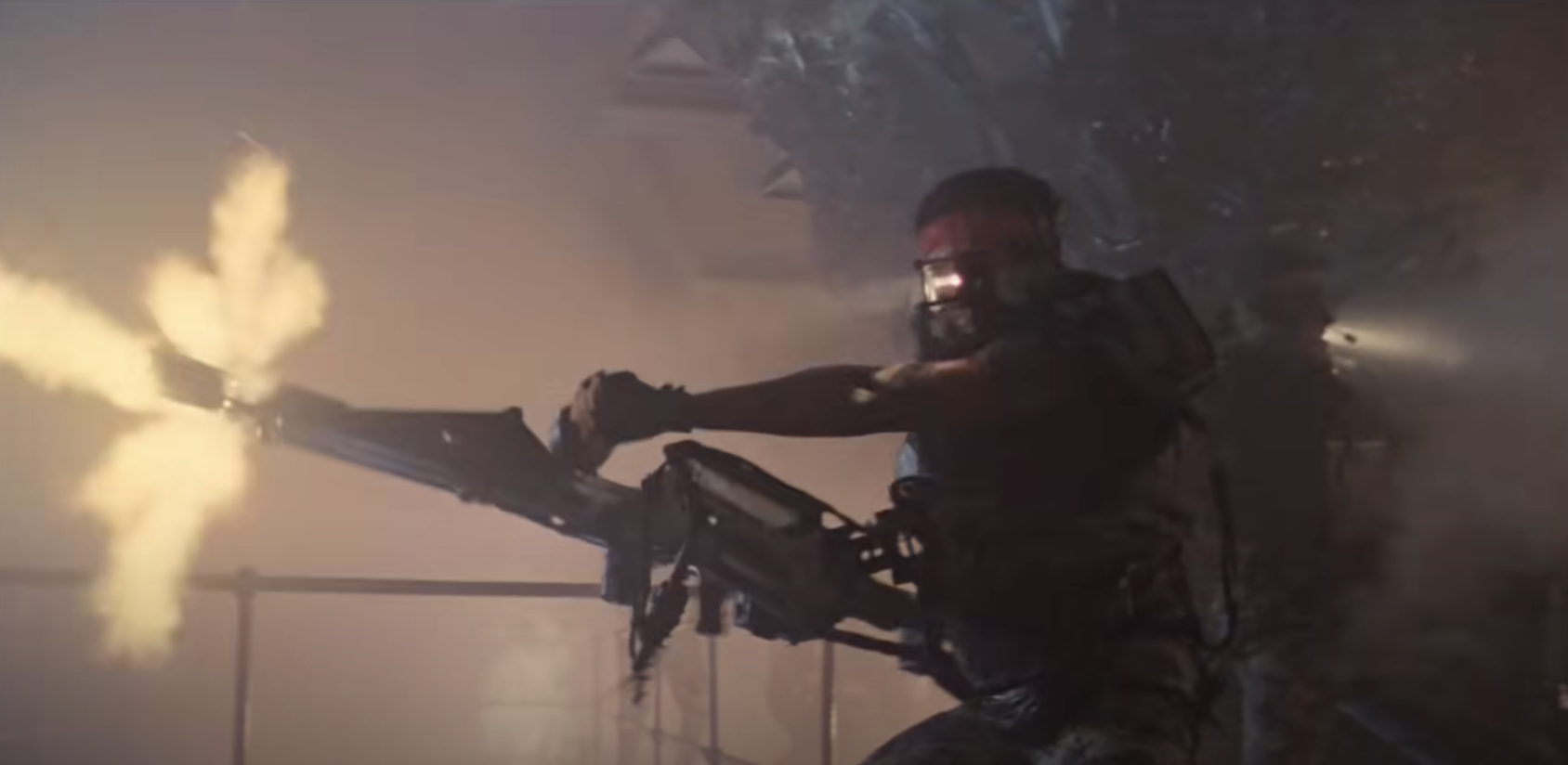 A space marine shoots a giant machine gun