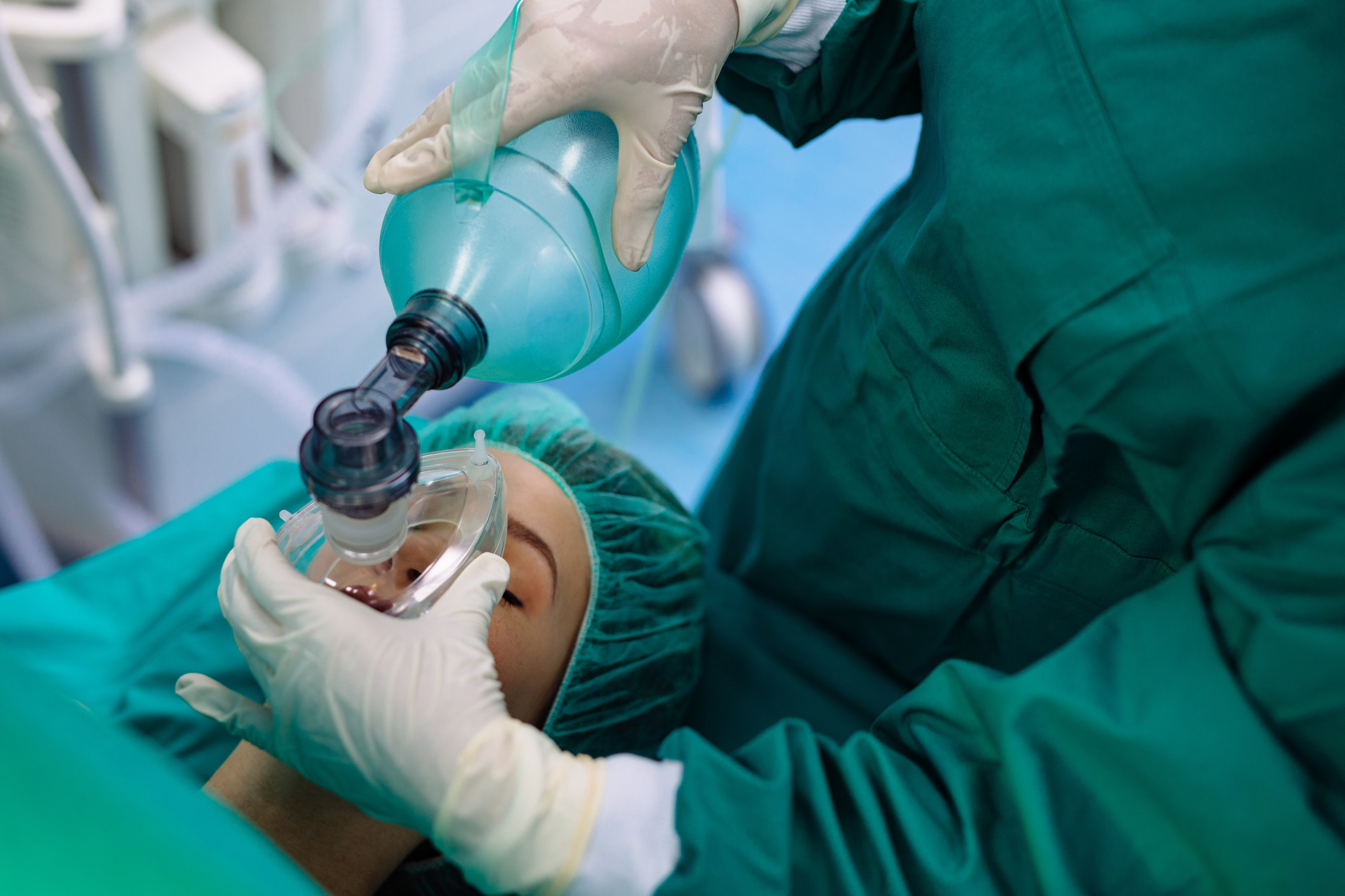 A doctor giving oxygen to a patient