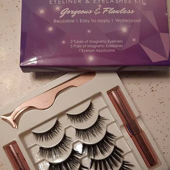 a reviewer photo of the false lashes, application tool, and magnetic eyeliner
