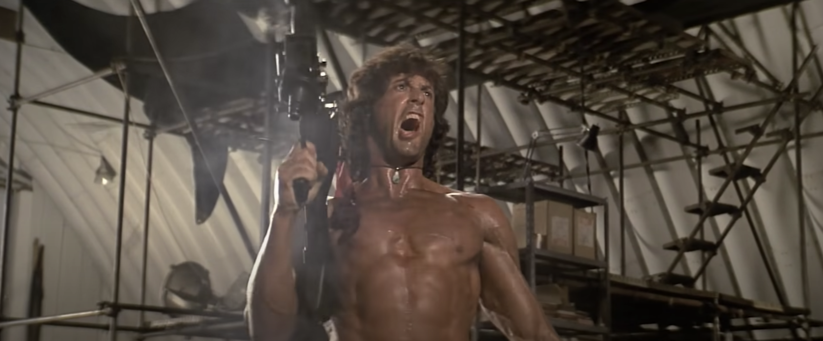Rambo fires a machine gun in the air and screams