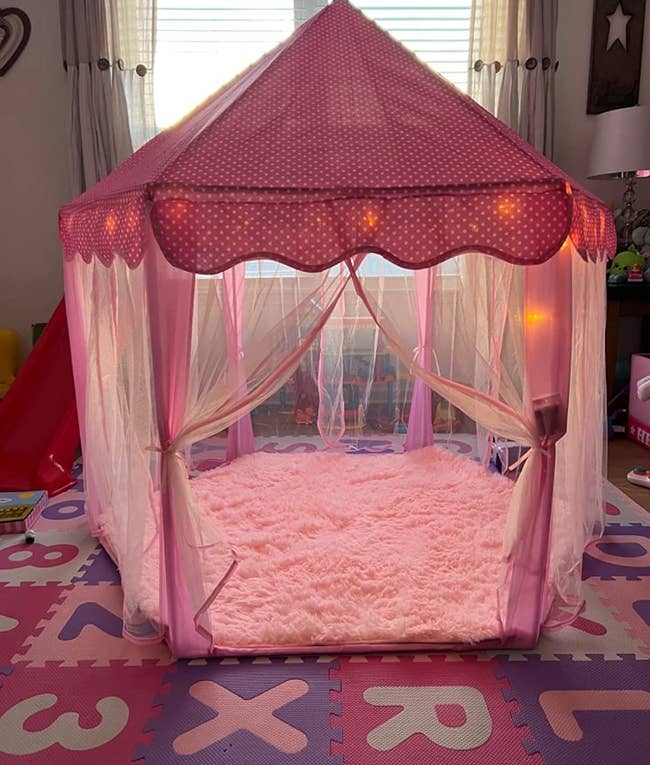 reviewer's photo of the tent in their kid's room