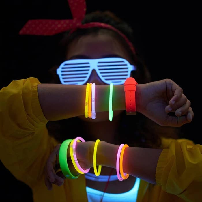 a person wearing glow stick bracelets