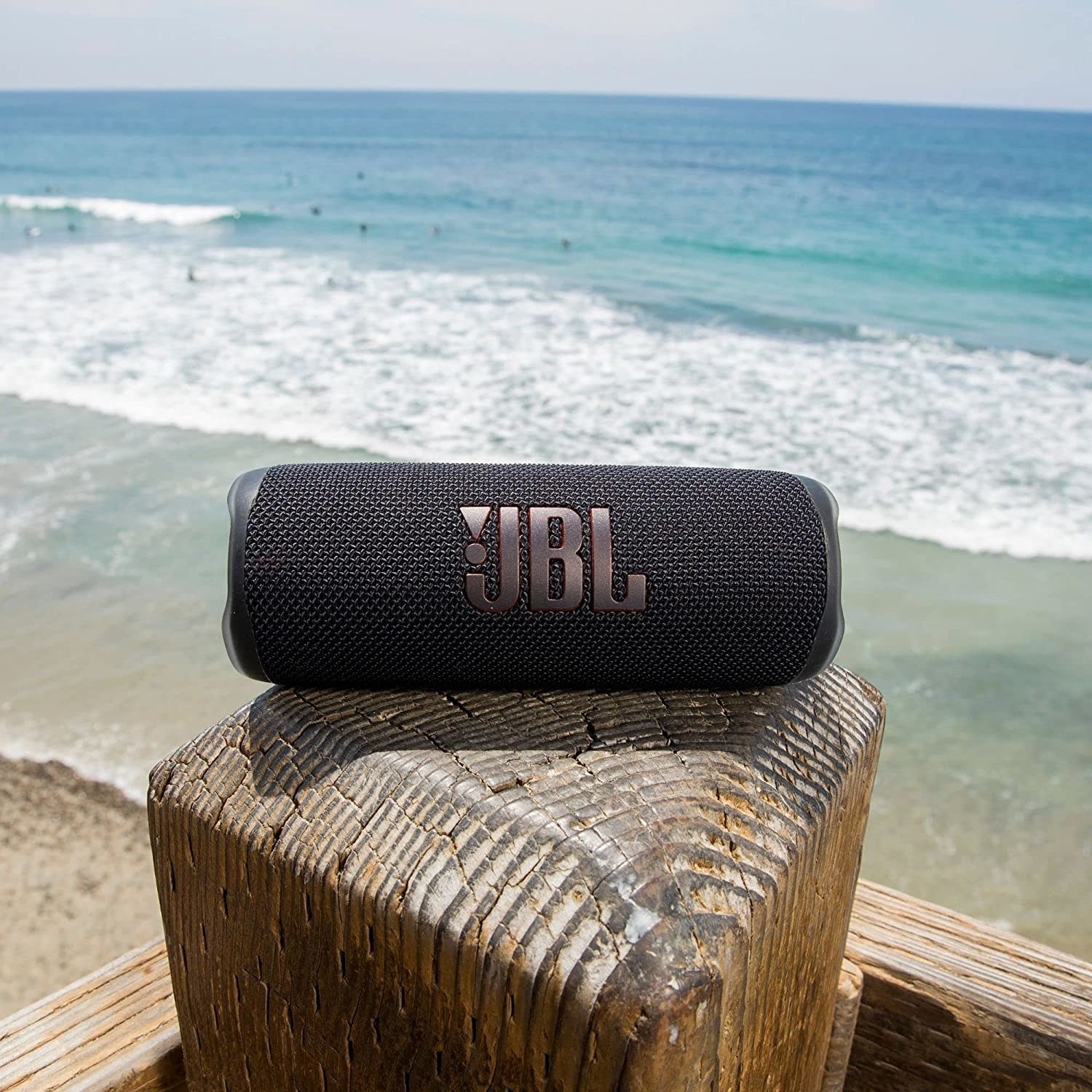 a JBL speaker on a beach