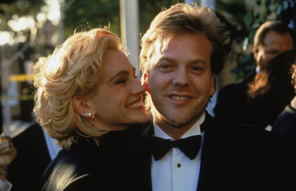 Julia Roberts and Kiefer Sutherland smiling together at a formal event