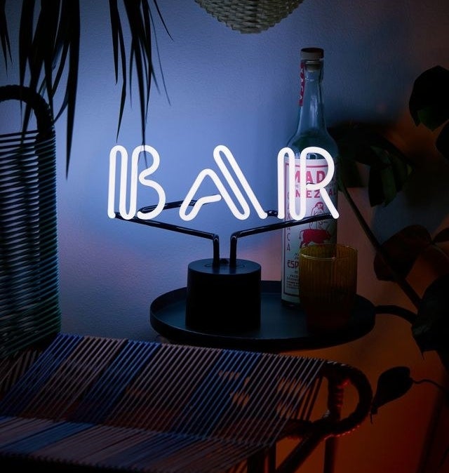 a neon light-up sign that says bar