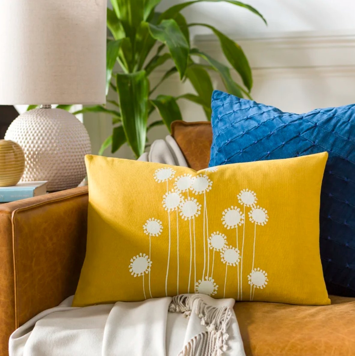 Yellow accent pillow with floral design