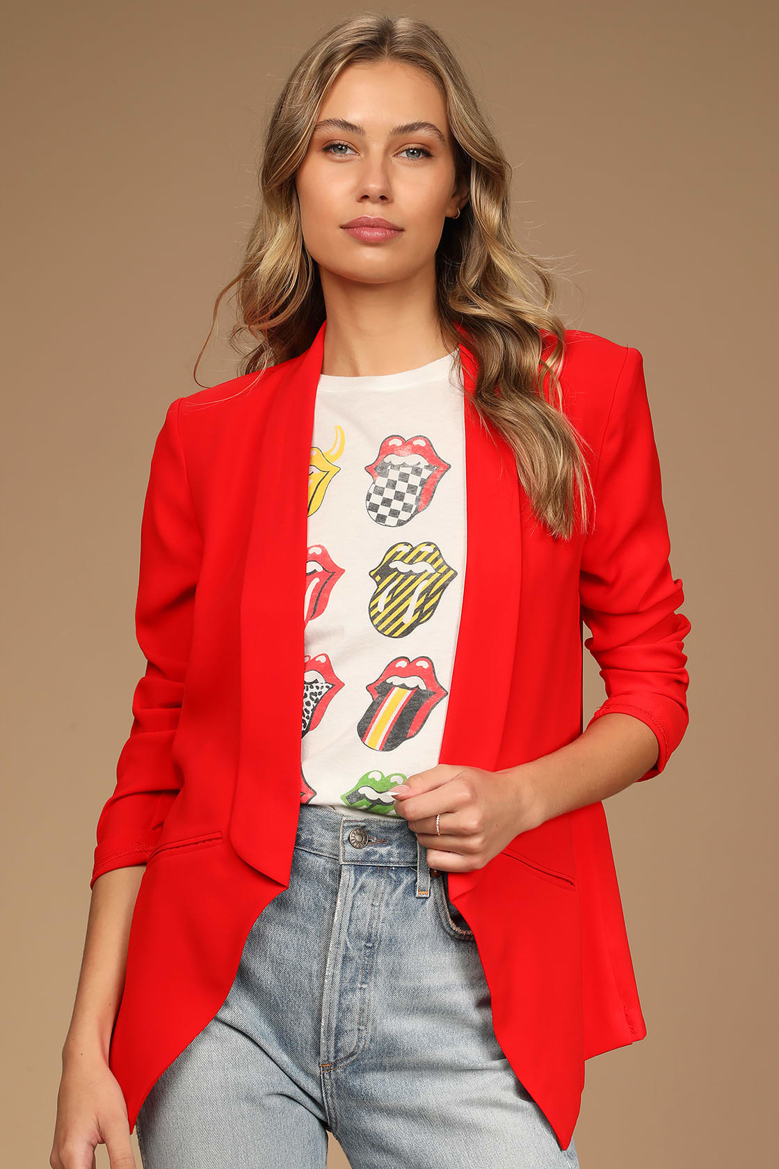 Model wearing red blazer over band tee with jeans