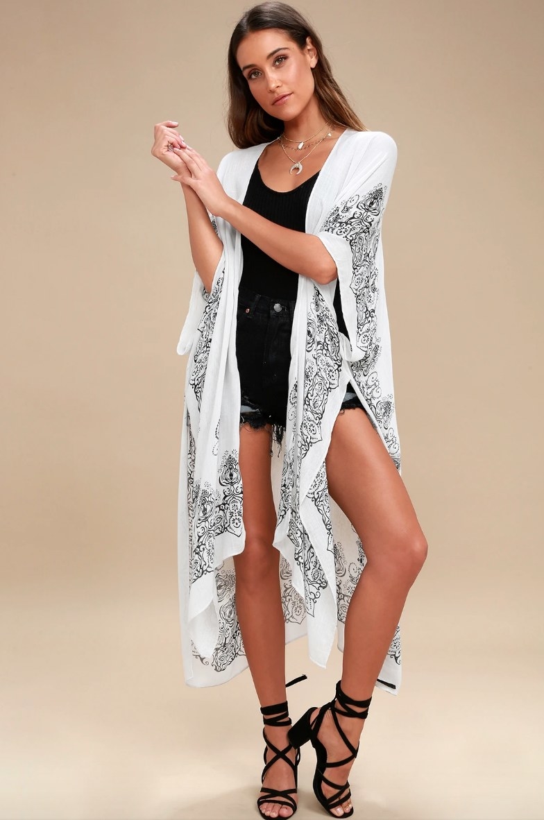 model wearing the white shawl with black patterns