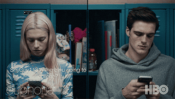 GIF, splitscreen of Hunter Schafer and Jacob Elordi as Jules and Nate in Euphoria, texting
