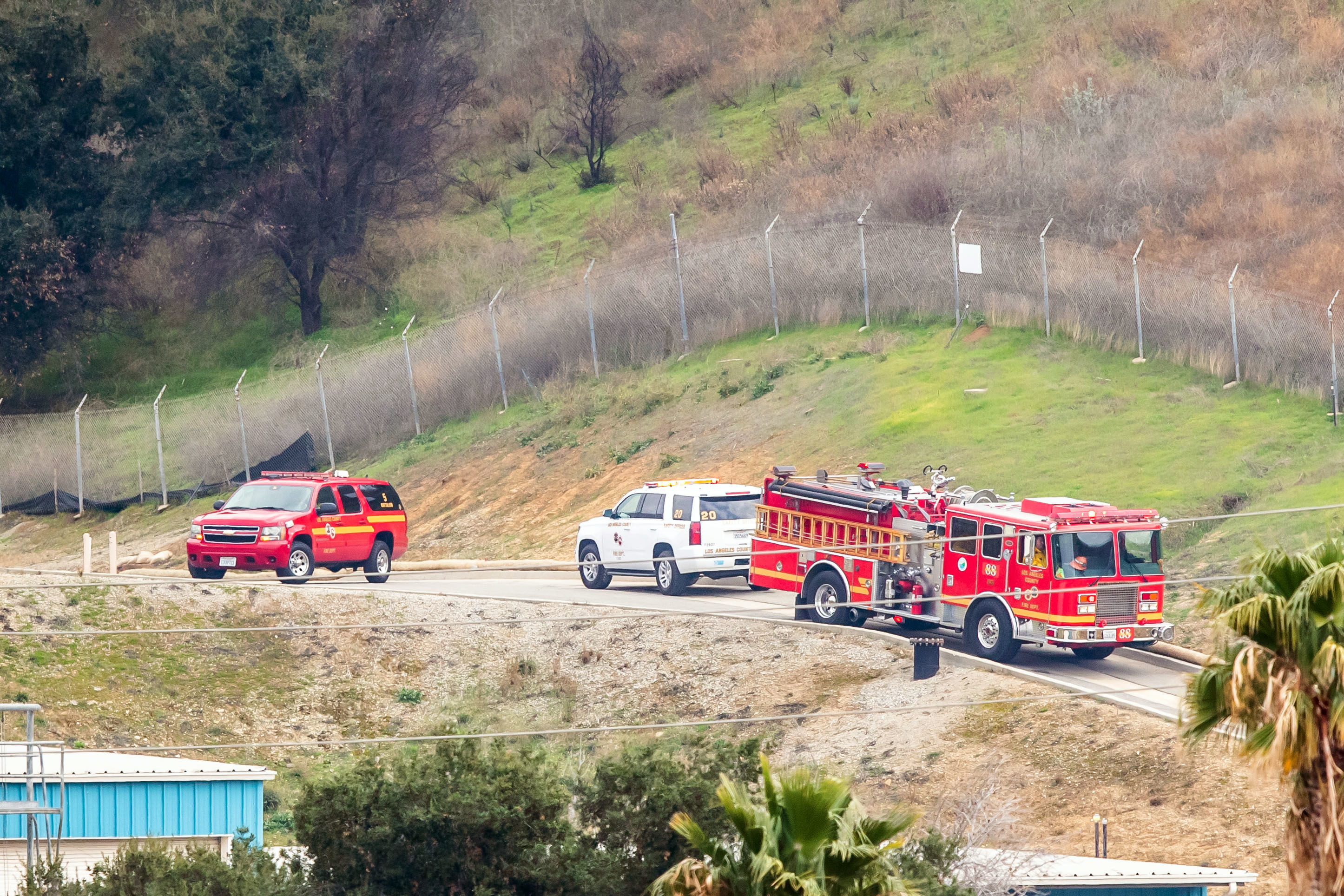 Firetrucks and a police vehicle at the site of a helicopter crash on January 26, 2020, in Calabasas, California