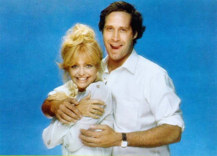 Goldie and Chevy Chase posing for the camera together