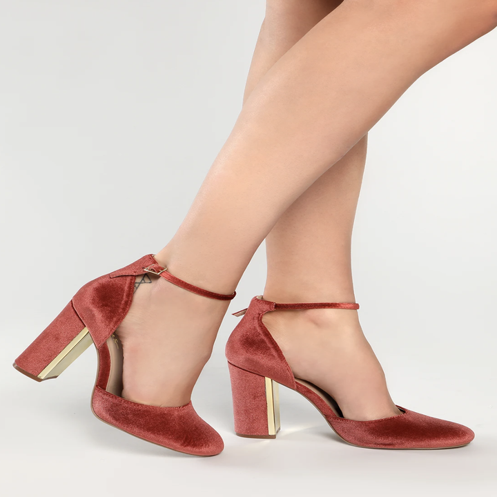 Model wearing closed toe red heels