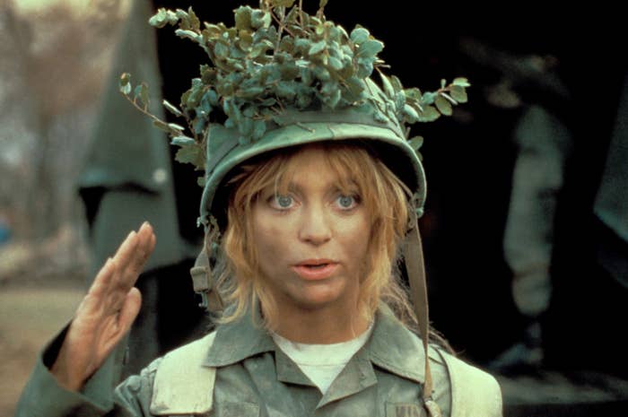 goldie hawn in an army outfit saluting