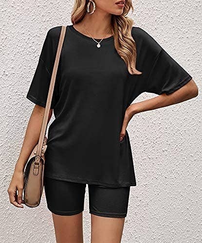 a person wearing the matching tee and short set with a stylish handbag