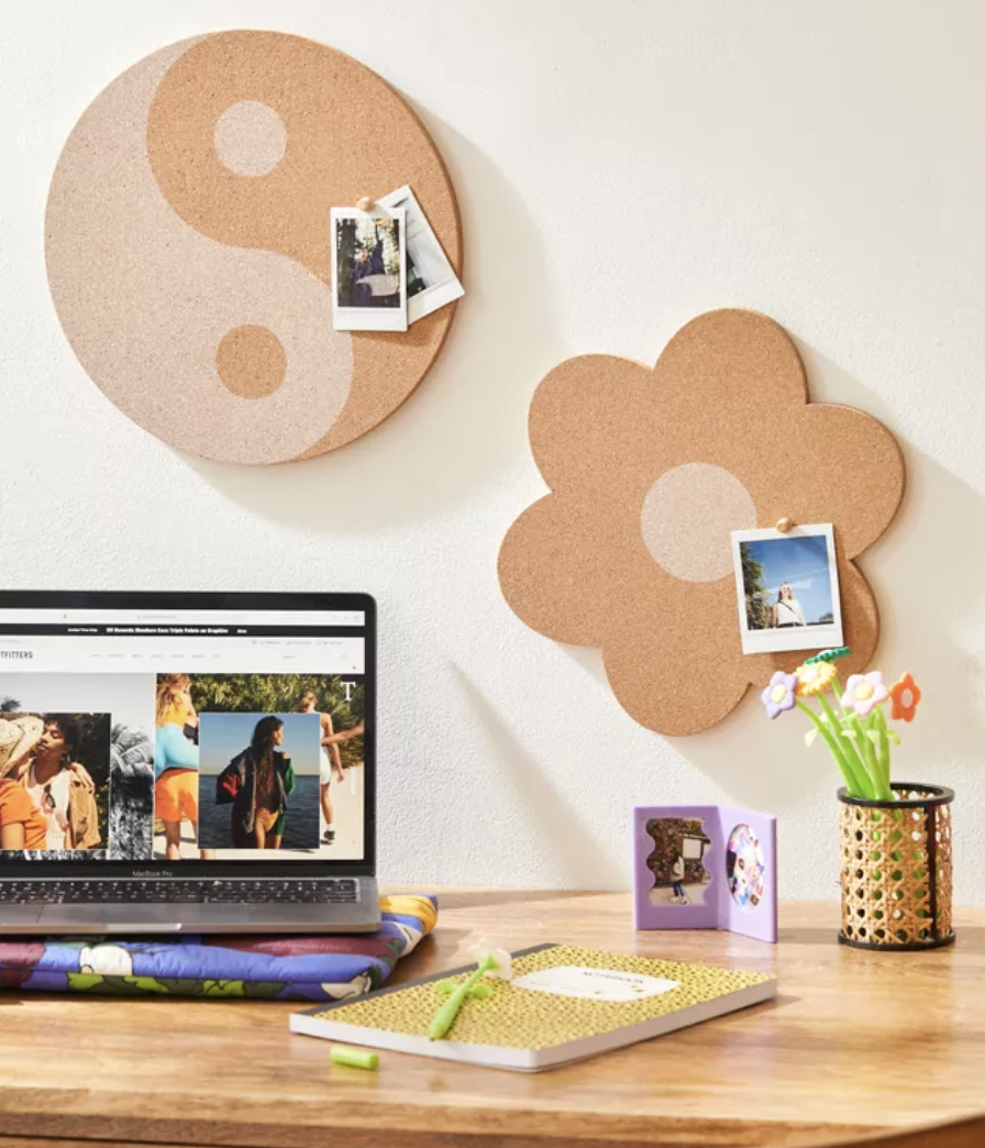 a pair of funky-shaped corkboards on a wall above a desk