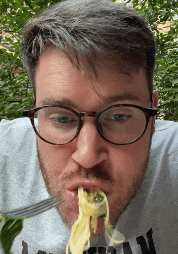 GIF of Ross, the writer, eating pasta