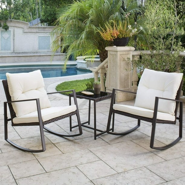 Rocking patio chairs with table in front on pool