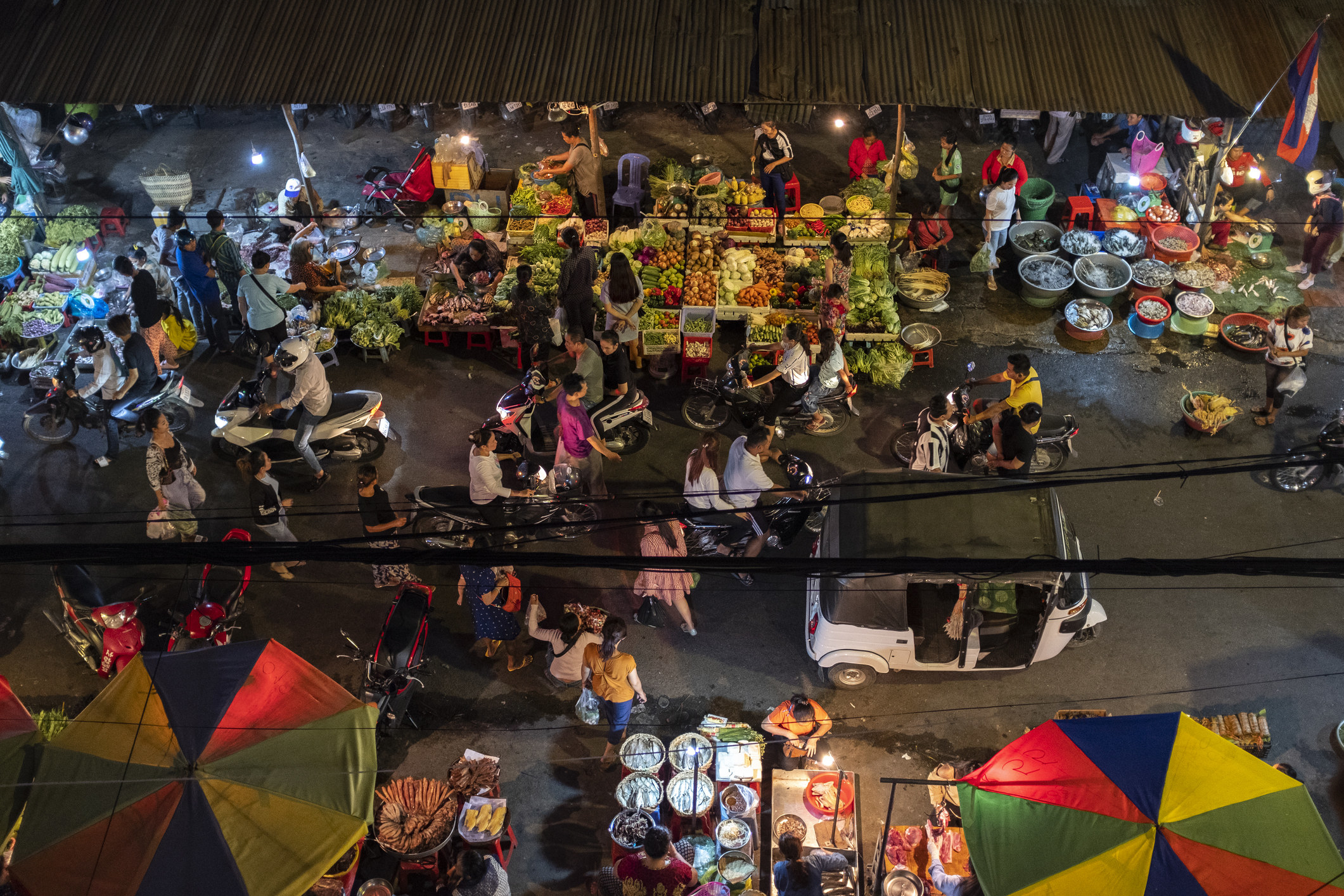 A group of people at Phnom Penh night market.