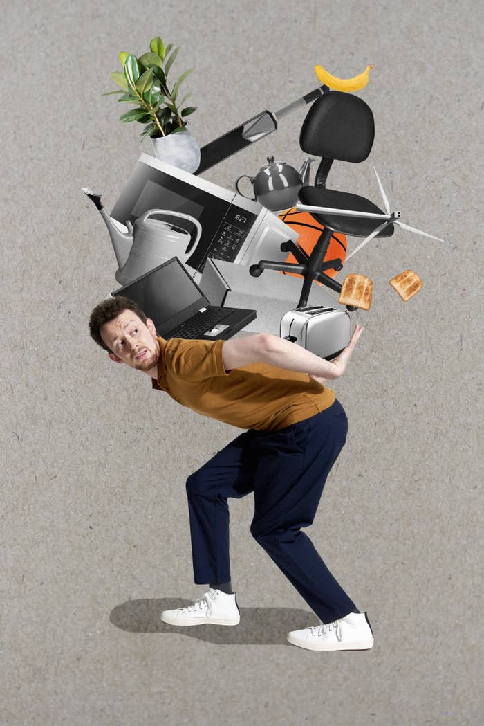 man carrying his whole office setup on his back illustrating the feeling of overwork