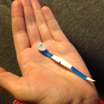 Reviewer holding Wisp toothbrush