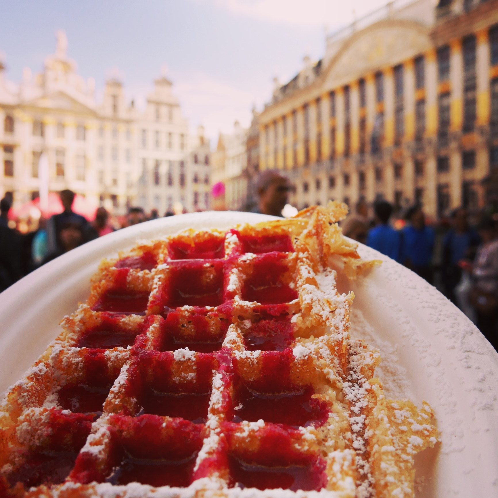 A close-up of a waffle with a city view in the backdrop.