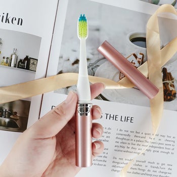 Model holding toothbrush