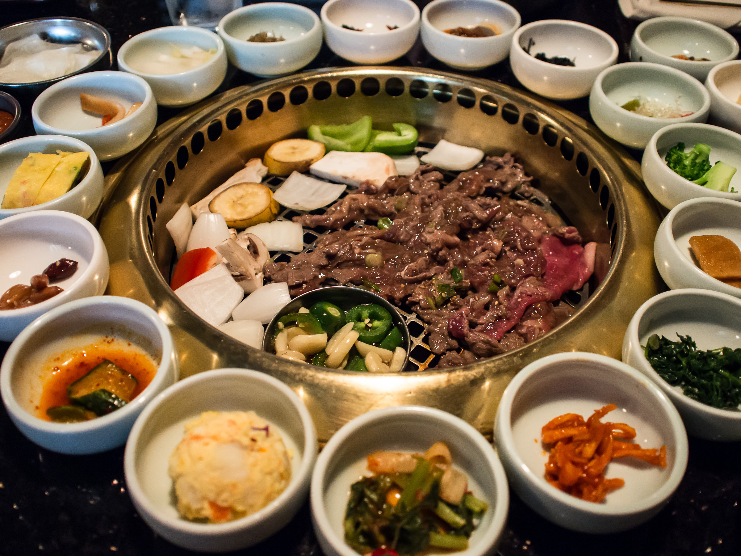 Korean barbecue with lots of banchan side dishes.