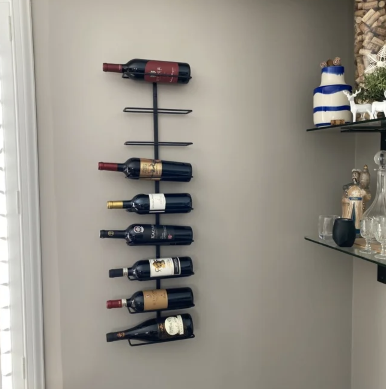 The wine rack with bottles in it on a reviewer&#x27;s wall