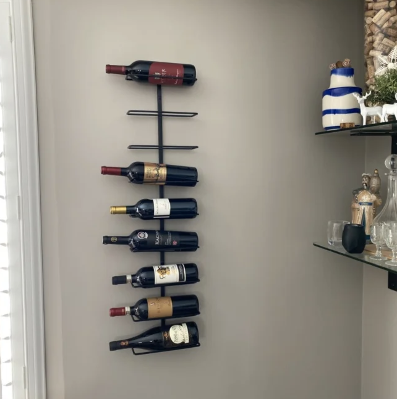 The wine rack with bottles in it on a reviewer's wall