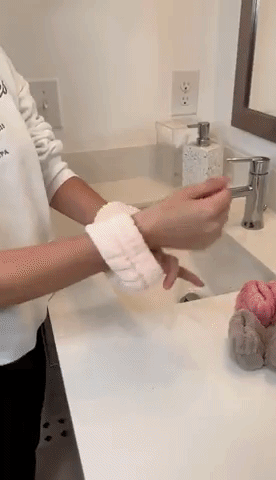 A gif of someone washing their hands with the cuffs on and water not going down the arms