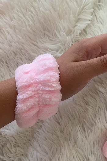 a reviewer shows the pink cuff on their wrist
