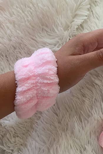 a reviewer shows the pink cuff on their wrist