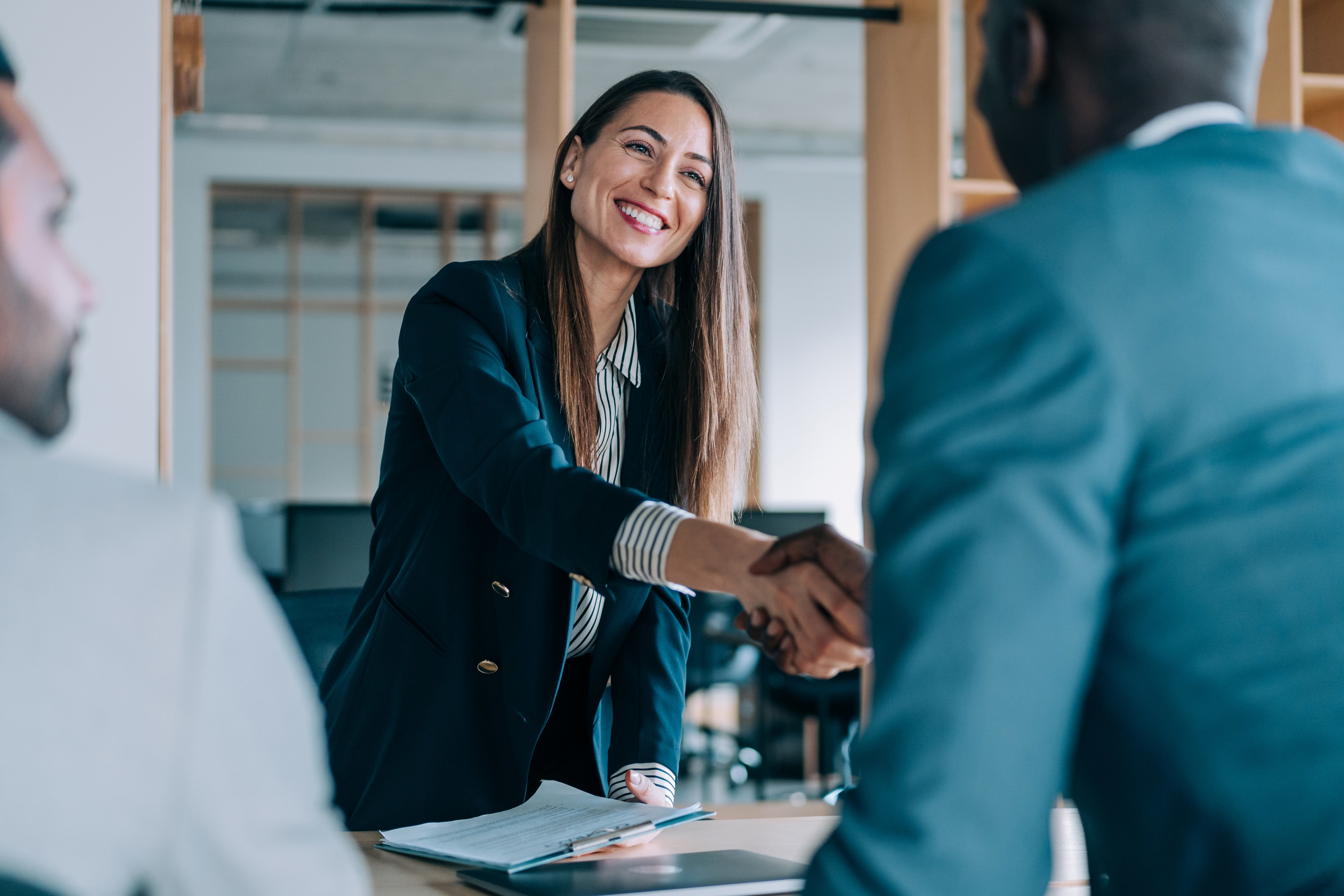 business people shaking hands in an office