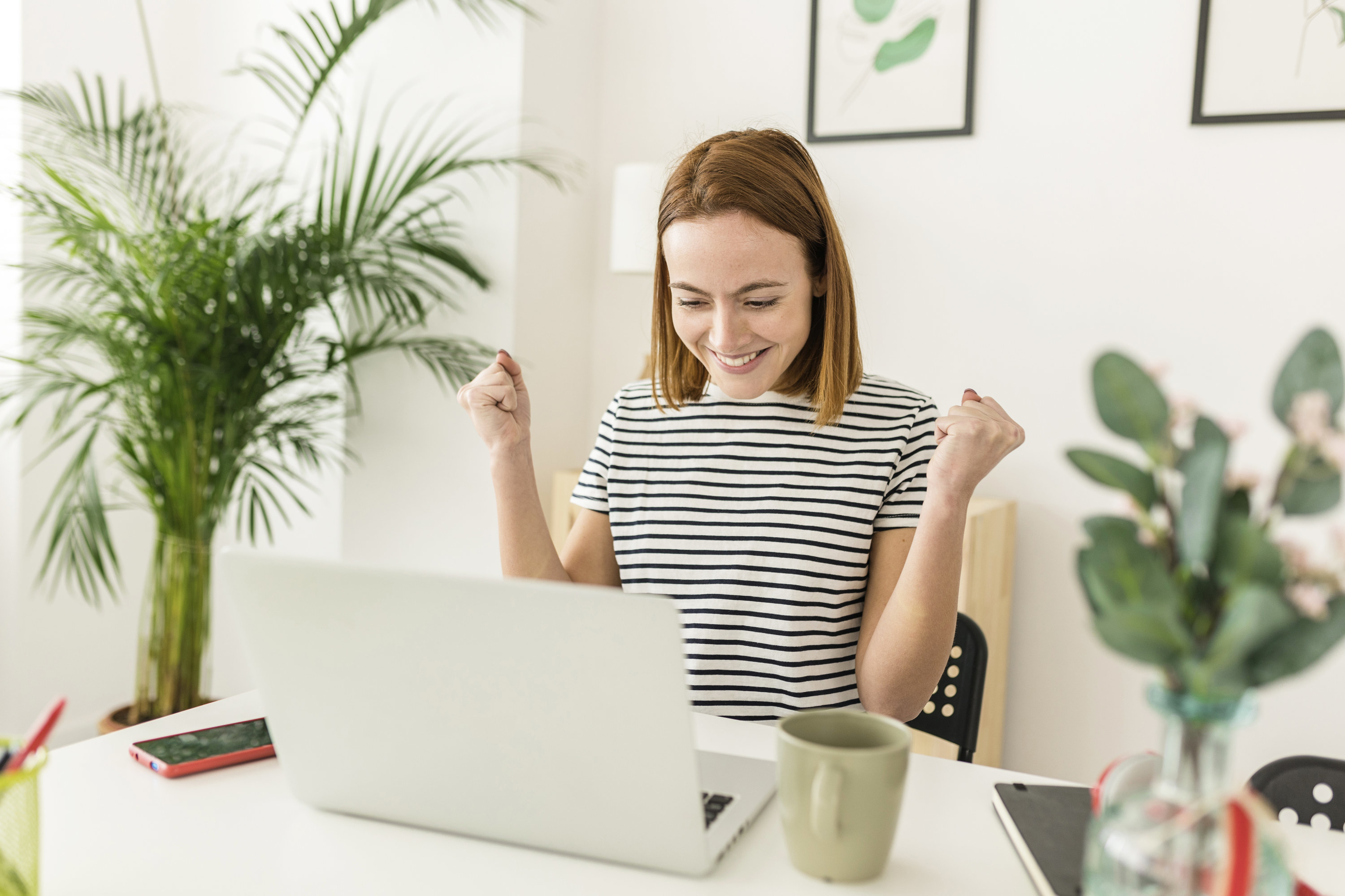 woman celebrating at her desk