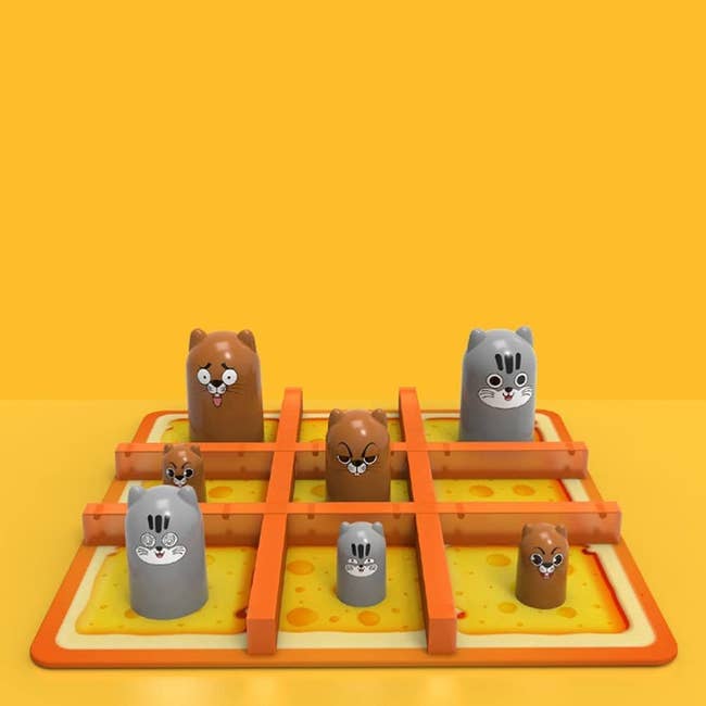 tic tac toe board that looks like cheese with eared tube-like characters in different sizes